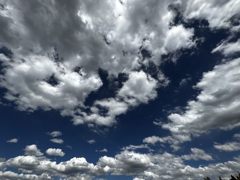 Dramatic cumulus clouds against a deep blue Colorado sky